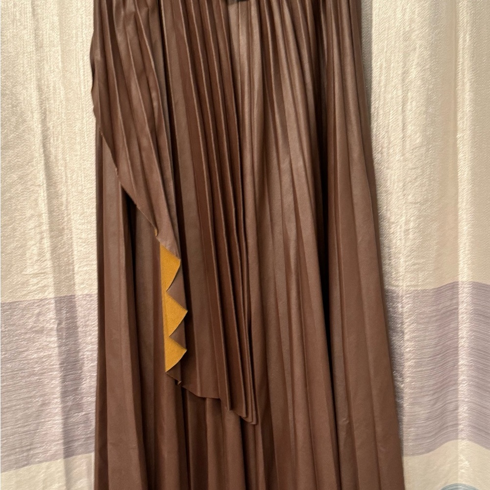 Brown pleaded vinyl skirt. Looks like real leather. Elastic waist.